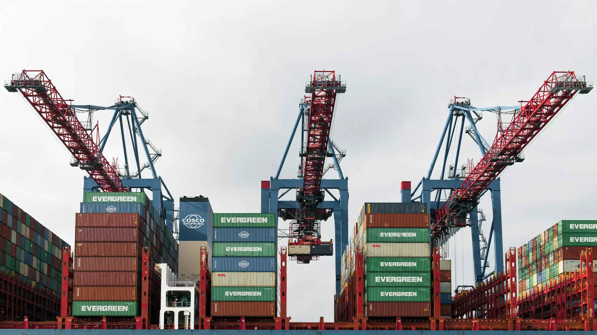 Cranes loading containers onto a vessel